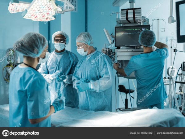 depositphotos 183824662 stock photo four multicultural doctors preparing surgery